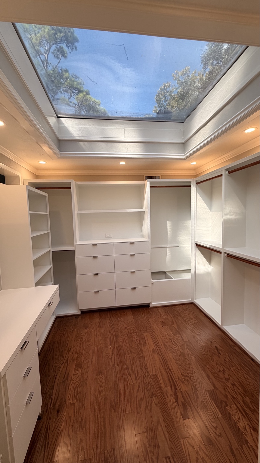 Finished custom closet beneath a skylight