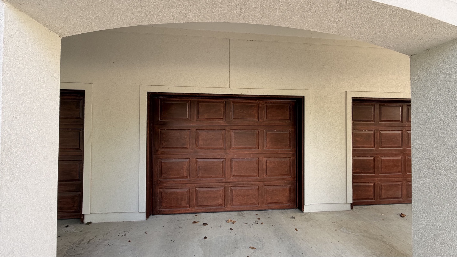Wood garage doors before preparation and refinishing
