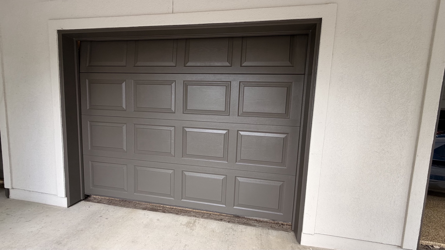 Angled view of the refinished charcoal garage door