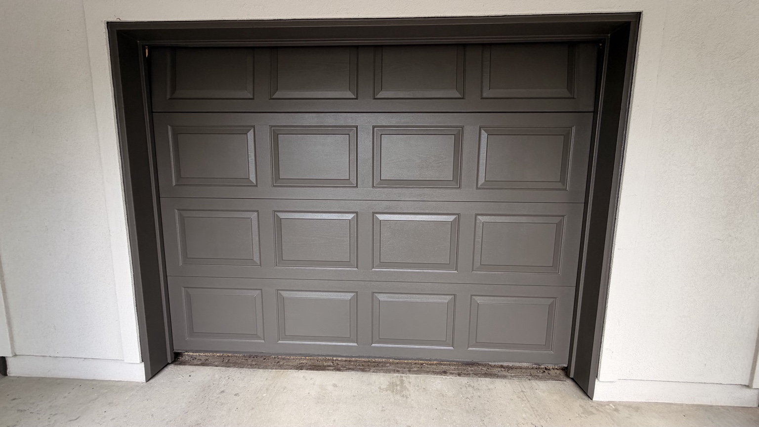 Finished charcoal paneled garage door