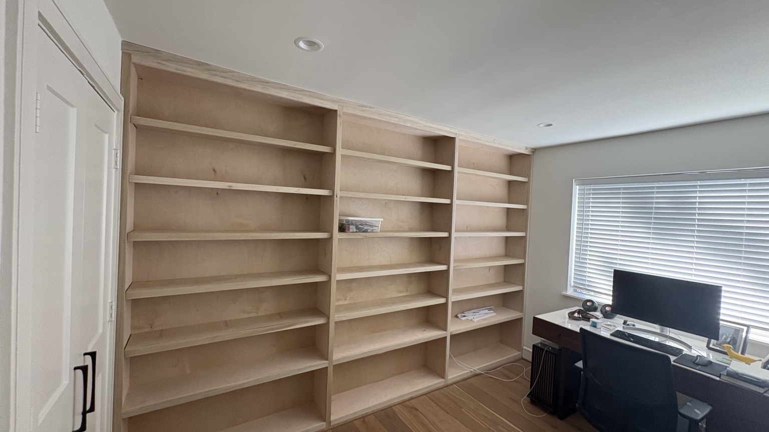 Raw wood built in shelving before refinishing
